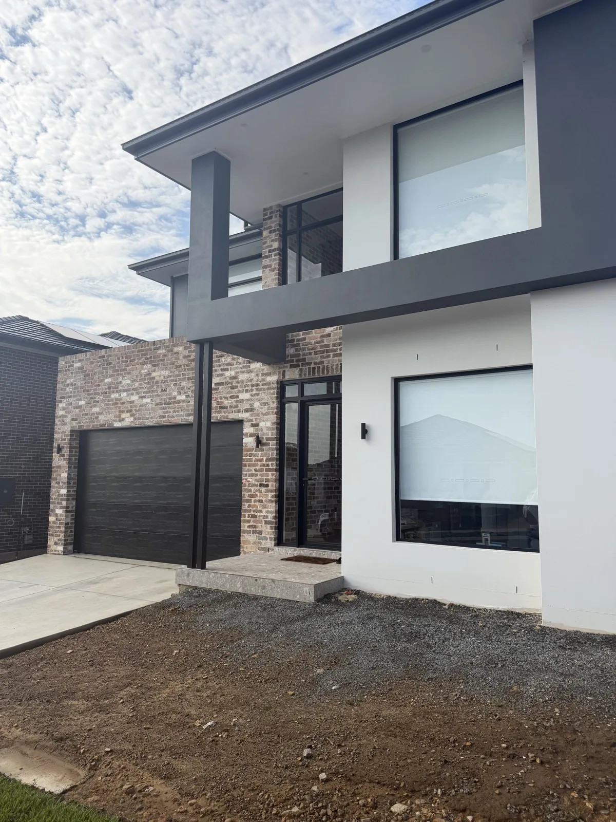 Modern two-storey new build finished in white and charcoal