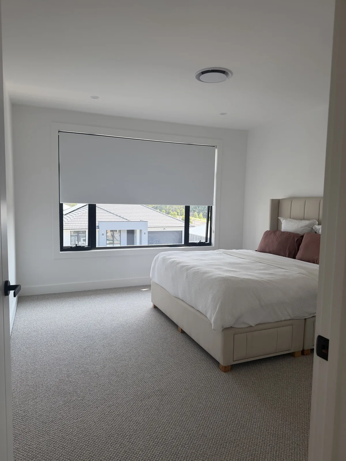 Bright bedroom with smooth white walls and ceiling after repaint