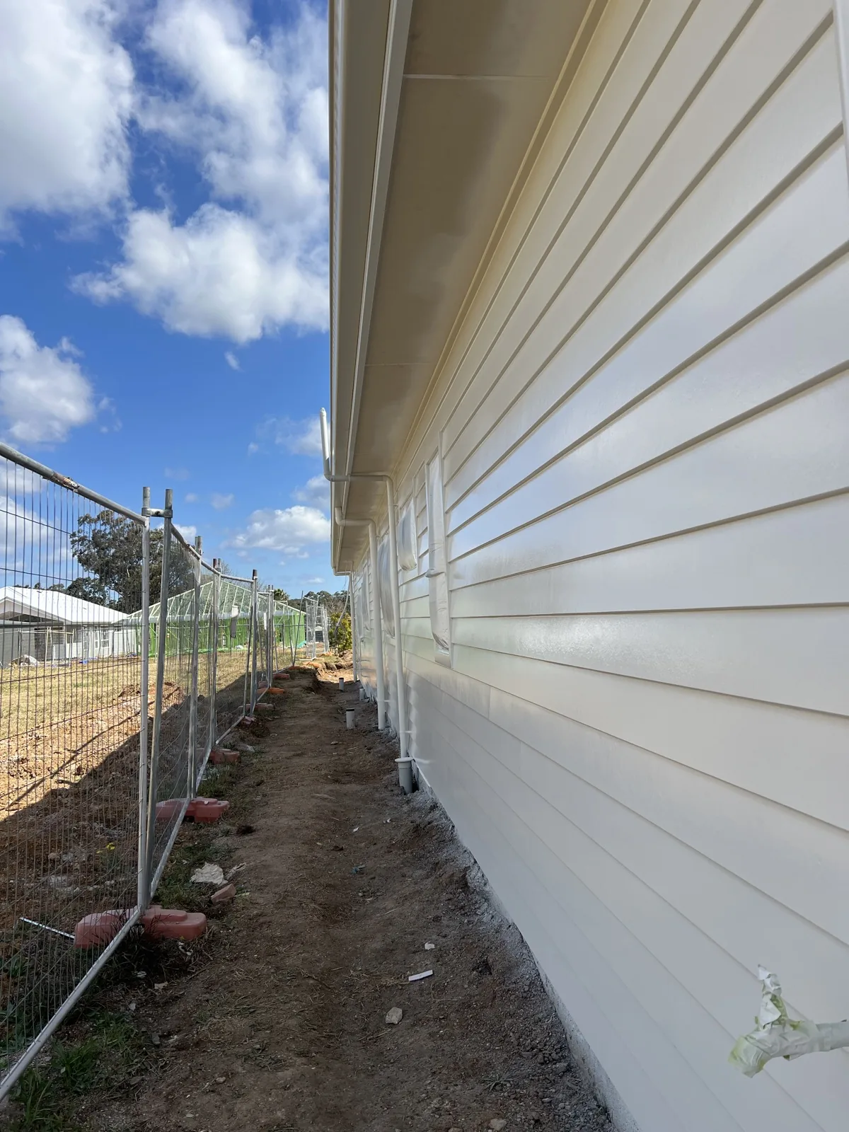 Side elevation of freshly painted weatherboard cladding